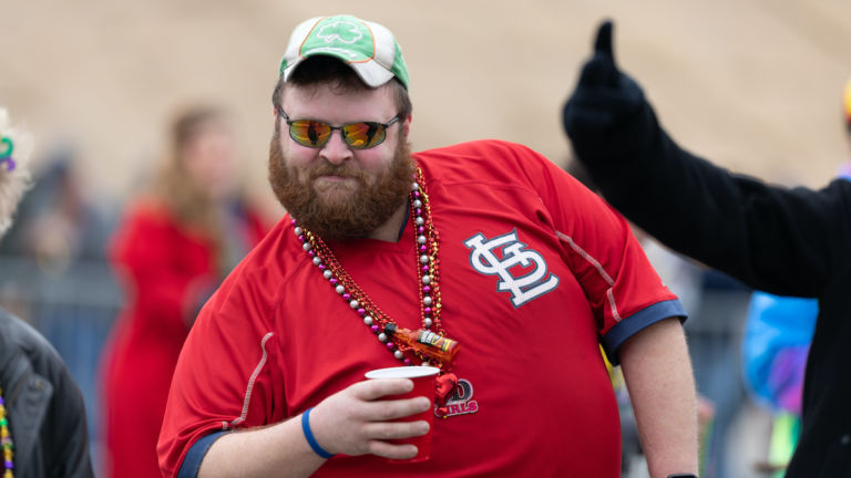 Bud Light Grand Parade, Man drinking and wearing a St Louis Cardinals shirt, posses for the camera during the parade