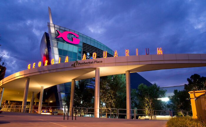 The Georgia Aquarium facade at night in Atlanta, Georgia. The boat shaped landmark is the world's largest aquarium with more than 8 million gallons of water. Photo by Shutterstock.