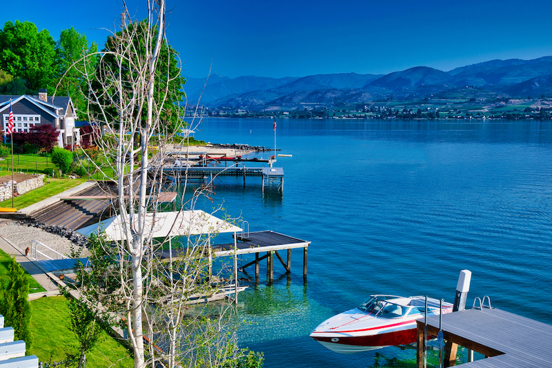 Greatest Summertime Lake Towns: A Lakeshore view at Lake Chelan in Washington State. Photo via Shutterstock.