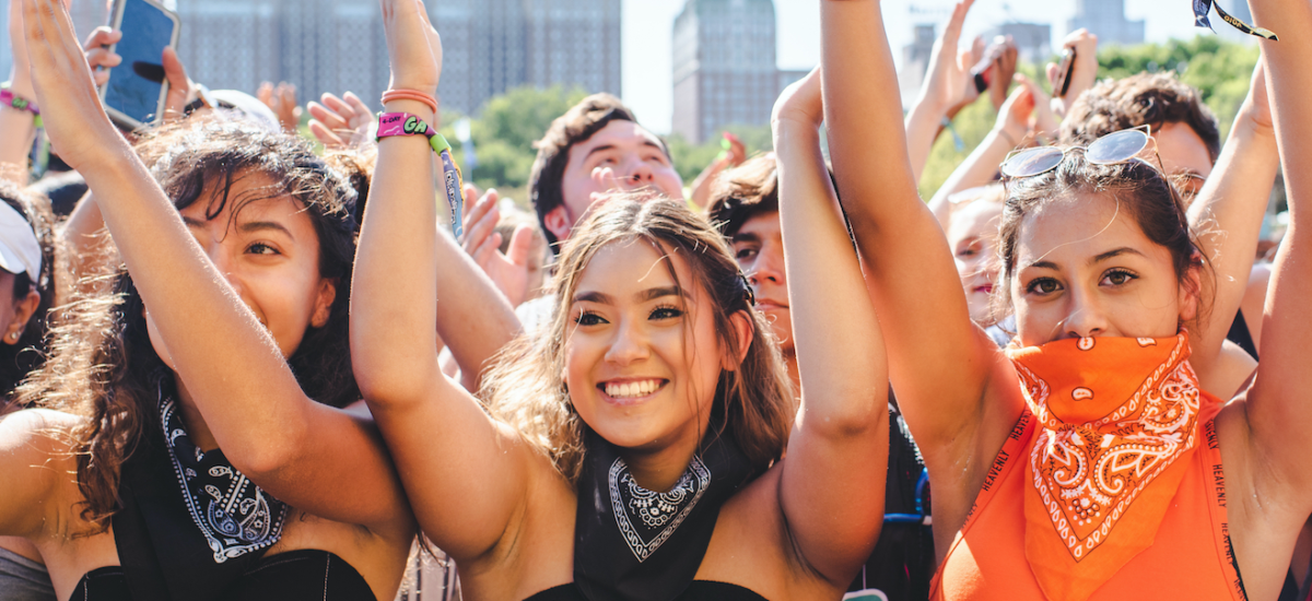 Chicago, Illinois - August 1st, 2019: Friends wait for a show to start at Lollapalooza in Grant Park, Chicago. Photo by Shutterstock.