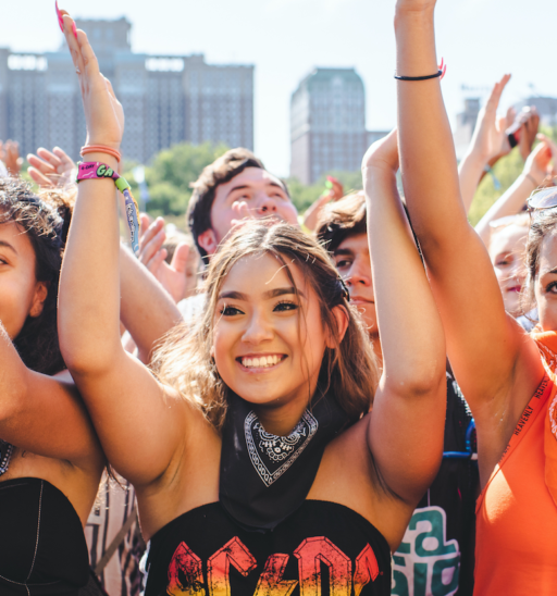 Chicago, Illinois - August 1st, 2019: Friends wait for a show to start at Lollapalooza in Grant Park, Chicago. Photo by Shutterstock.