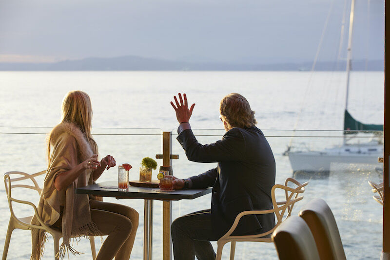 Couple dining on the deck at the Edgewater hotel in Seattle. Photo via the hotel.