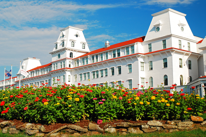 A garden grows n front of the Wentworth Hotel, a classic grand hotel along the New Hampshire coast. Photo via Shutterstock.