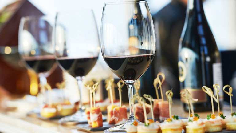 Glasses of wine on bartender counter in restaurant. Photo by Shutterstock.