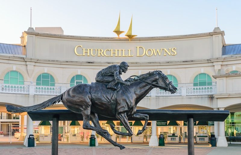 Entrance to Churchill Downs featuring a statue of 2006 Kentucky Derby Champion Barbaro. Photo by Shutterstock.