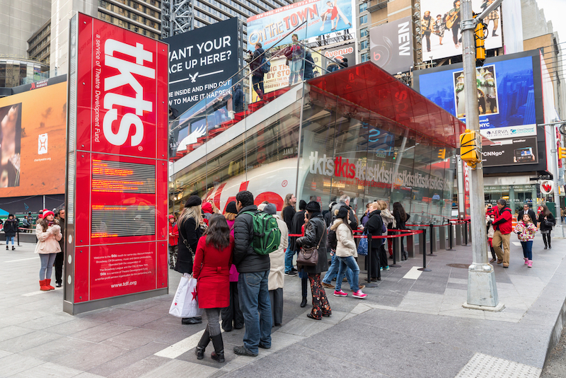 People buying Broadway tickets at TKTS discount ticket booth in Times Square. Photo by Shutterstock.