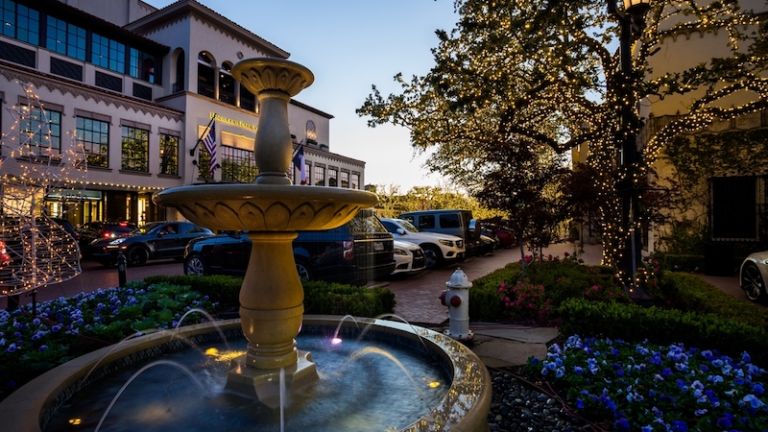 Dallas, Texas - Highland Park Village in dusk. Christmas lights and the beautiful fountain at twilight. Photo by Shutterstock.