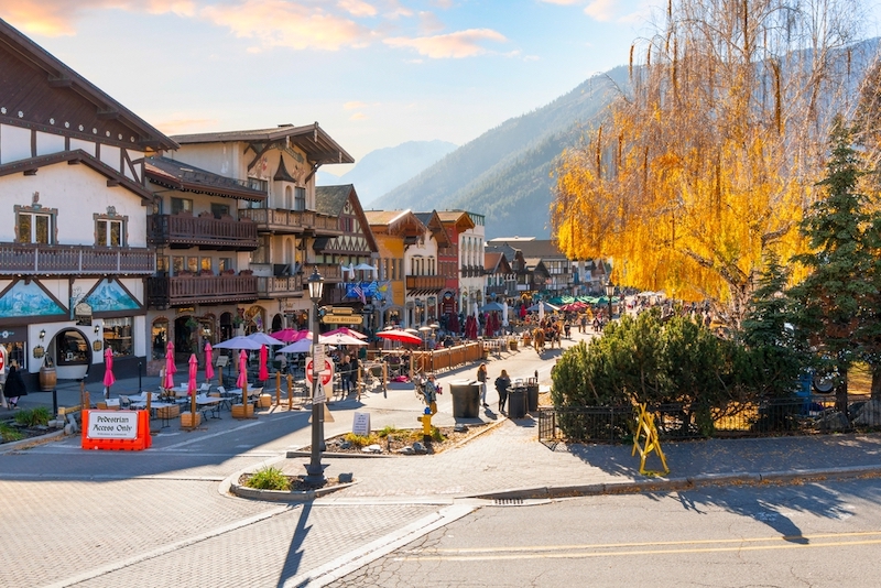 Autumn afternoon at the Bavarian themed village of Leavenworth, Washington, with themed sidewalk cafes and shops on the pedestrian main street. Photo by Shutterstock.