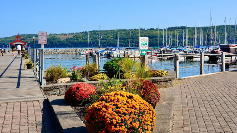 Seneca Lake as one of Finger Lakes in New York. Beautiful Seneca Harbor Park, early fall in a blue sky. Today’s waterfront visitors enjoy a picturesque view from the Harbor Park at Watkins Glen.