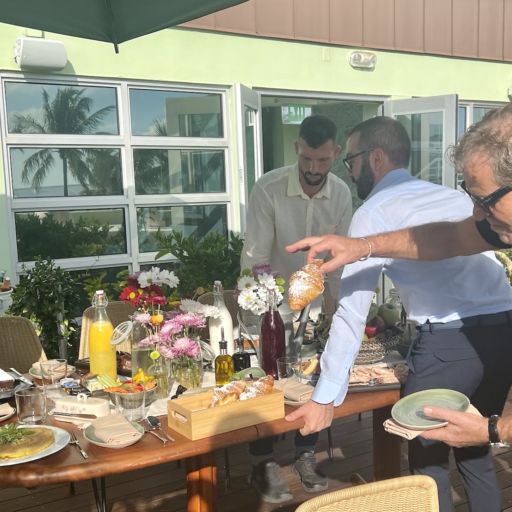 Billionaire Diesel founder Renzo Rosso plucks a cornetto from a moving breakfast table on the balcony of his Pelican Hotel penthouse. Photo by Adam Robb.