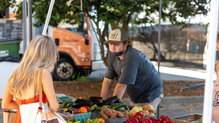 Jacksonville, Florida - Saturday May 1, 2021: Riverside art market event hosted many local artists, farms and businesses. Families and young people gather under the Fuller Warren Bridge. Photo via Shutterstock.