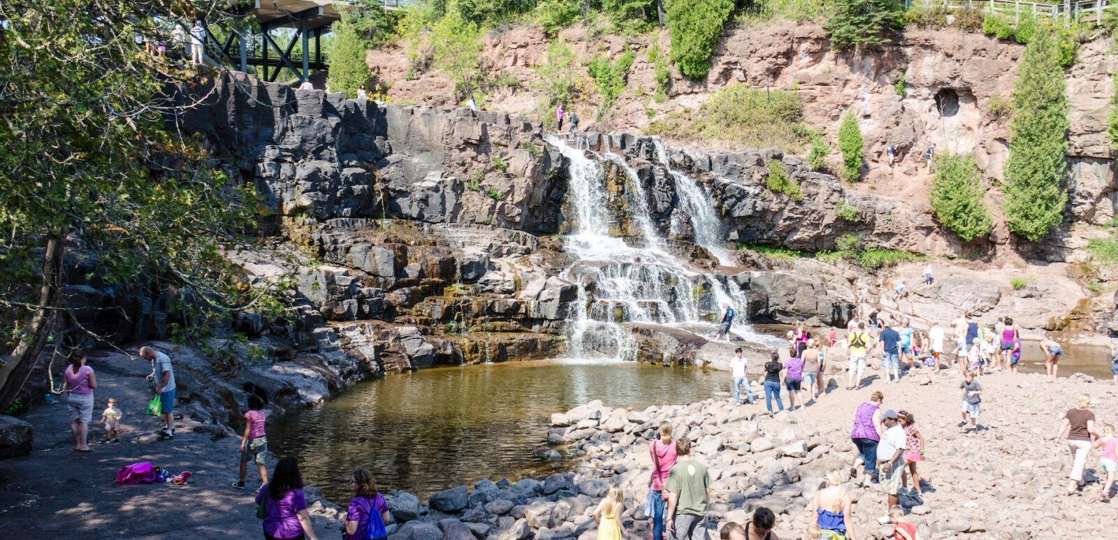 Duluth, Minnesota: Gooseberry Falls, a popular waterfall near Lake Superior, attracts a crowd of visitors on a summer day. Photo via Shutterstock.