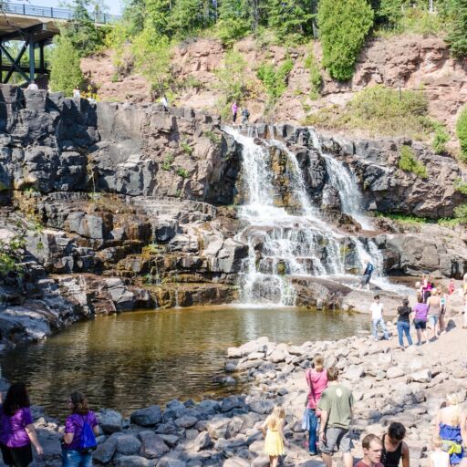 Duluth, Minnesota: Gooseberry Falls, a popular waterfall near Lake Superior, attracts a crowd of visitors on a summer day. Photo via Shutterstock.