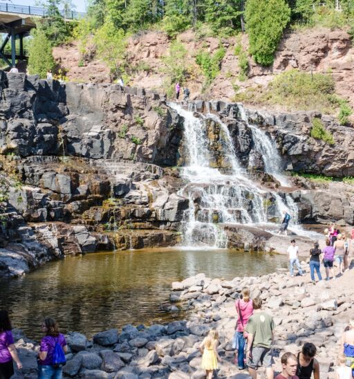 Duluth, Minnesota: Gooseberry Falls, a popular waterfall near Lake Superior, attracts a crowd of visitors on a summer day. Photo via Shutterstock.