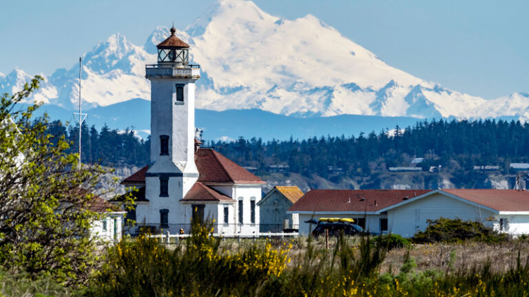 Mount Baker and lighthouse in Port Townsend, Washington. Photo by Shutterstock.
