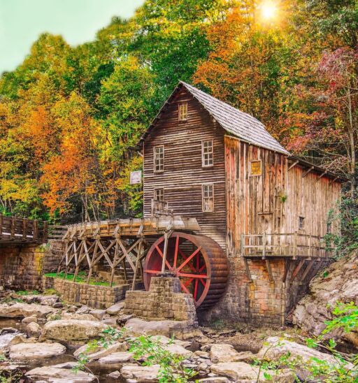 Autumn sun rays on fall foliage at Glade Creek grist mill at Babcock State Park near Fayetteville WV