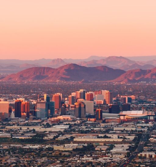 Phoenix, Arizona with its downtown lit by the last rays of sun at the dusk.
