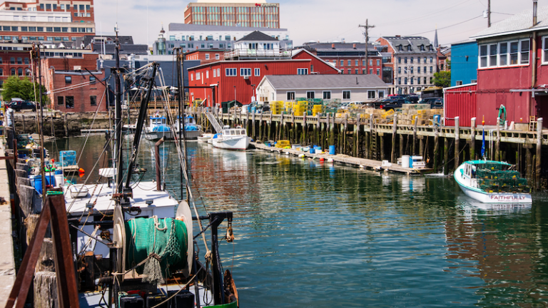Scenic view of working fishing ships and boats, dockside in Portland Maine's harbor.