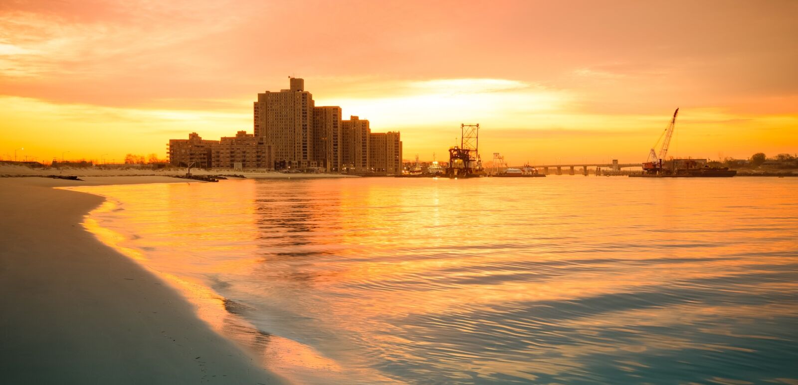 Warm sunrise on the coast. Overlooking the Atlantic Beach Bridge. East rockaway Intel. New-York. US East Coast.