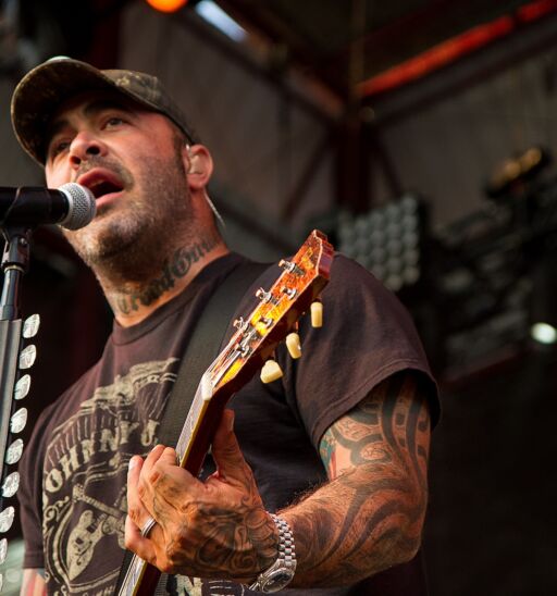 Aaron Lewis plays his guitar during a performance of Staind.